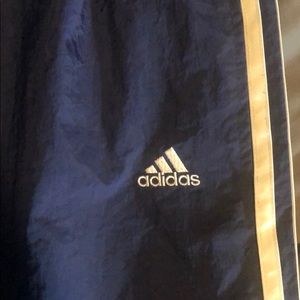 Navy and white striped Adidas track pants